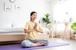 © Kawee - Asian young beautiful sportswoman doing yoga pilates workout at home.
