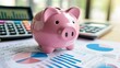 © keks20034 - A pink piggy bank on the background of financial charts and a calculator symbolizes financial management