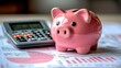 © keks20034 - A pink piggy bank on the background of financial charts and a calculator symbolizes financial management