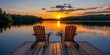 © Thanthara - Two wooden chairs on a wood pier overlooking a lake at sunset