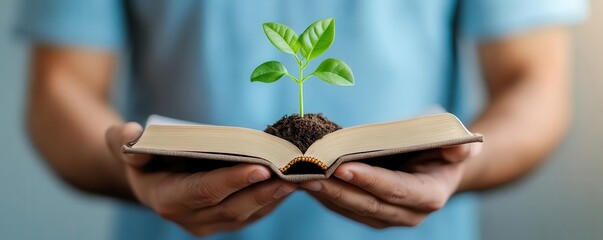 man holding a small plant growing from a book, symbolizing knowledge and growth, productivity, lifel