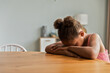 © Cavan Images - African American girls sitting at table feeling sad and upset