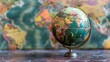 © improvee design - vintage globe sits on a wooden table, with a blurred background of a world map. The globe represents exploration, knowledge, and the interconnectedness of the world.