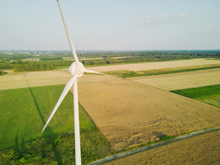 Wall Mural - Wind turbine in an open field at sunset