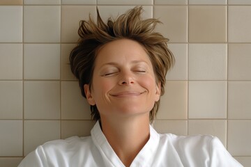 Sticker - Woman lying down with eyes closed expressing a sense of relaxation and tranquility in a minimalistic tiled environment highlighting the simplicity of a peaceful moment