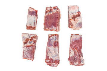 A close up of a piece of meat with a white background. The meat is cut into six pieces Pork meat isolated on white background.