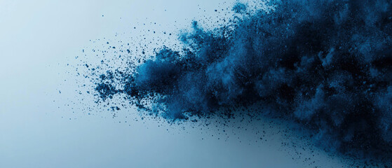 Abstract blue powder explosion on white background. Vibrant color dust particles spreading in the air. Creative artistic design.