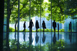 © Noufaldi - Silhouettes of people walking in a modern office building with large windows and green trees