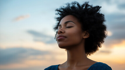 close-up portrait of black woman with eyes closed and head tilted back, looking up at the sky with p