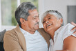 © peopleimages.com - Old couple, hug and happy laugh in home, weekend romance and couch date in retirement for love. Senior people, funny conversation and marriage cuddle on sofa, talking embrace and joke for bonding