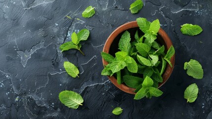 Poster - A bowl filled with freshly picked mint leaves, set against a dark textured background, showcasing herbs and culinary delight.