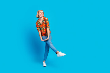 Sticker - Photo of positive charming glad girl wear stylish print clothes have fun look empty space isolated on blue color background