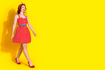 Poster - Full length photo of lovely adorable lady in trendy dress high heels going empty space isolated on yellow color background