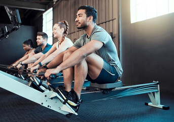 fitness, class and man on rowing machine for health, wellness and body workout in gym. exercise, hea