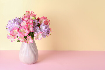 Poster - Beautiful alstroemeria flowers in vase on color background, space for text