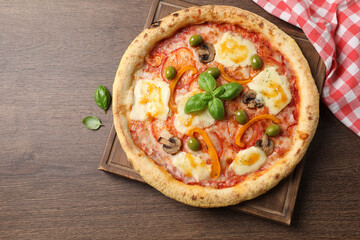 Wall Mural - Delicious vegetarian pizza on wooden table, top view