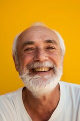 Wall Mural - A man with a white shirt and gray hair is smiling. He has a beard and a mustache