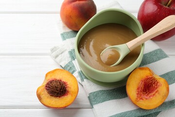 Sticker - Delicious baby food in bowl and ingredients on white wooden table, closeup