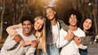 © Prostock-studio - Positive group of multiracial young friends having fun at public park, hugging and smiling