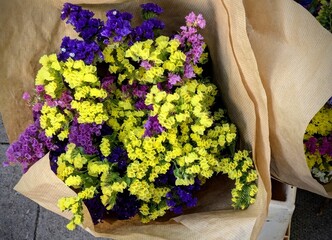 Bouquet of colorful bright flowers in craft paper