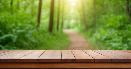 Empty wooden table top with blurred forest path background