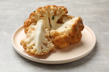 Wall Mural - Delicious baked cauliflower on gray textured table, closeup