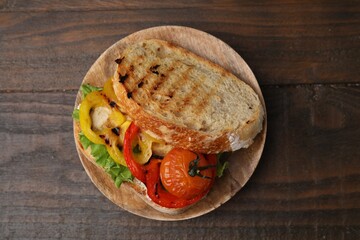 Wall Mural - Tasty sandwich with grilled vegetables on wooden table, top view