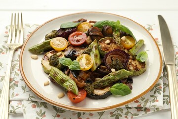 Delicious salad with grilled vegetables served on white table, closeup