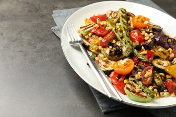 Sticker - Delicious salad with grilled vegetables served on gray textured table, closeup. Space for text