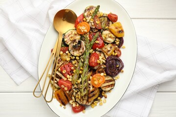 Wall Mural - Delicious salad with grilled vegetables served on white wooden table, top view