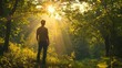 © Media Srock - Man From Back Standing in Sunlit Forest.
