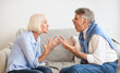© Prostock-studio - Senior couple quarrelling with each other and shouting, sitting on sofa at home
