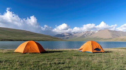 A vibrant orange camping tent rests by a tranquil lake, surrounded by mountains, as a person captures the serene autumn landscape from inside the tent