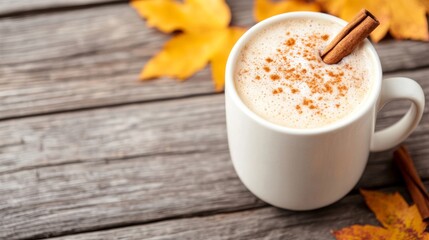 Canvas Print - Pumpkin spice latte topped with a cinnamon stick nestles on an aged wooden table encapsulating the snug autumnal spirit of October 