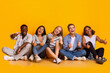 © Prostock-studio - Positive group of international students showing thumbs up over yellow background, enjoying life