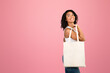 © Prostock-studio - Ecology Concept. Black woman standing with white cotton bag looking at copy space over white background, mock up