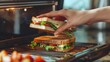 © Alexander - Female hand carefully opening the lid of a sandwich making machine with hot selective focus and close up homemade food concept