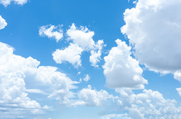 a bright blue sky with fluffy white clouds on a clear summer day