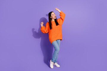 Wall Mural - Photo of lovely adorable glad girl wear stylish orange clothes have fun isolated on purple color background