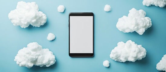 Poster - Top view of blank paper clouds next to a smartphone and a digital tablet with a blank screen set against a blue background. with copy space image. Place for adding text or design
