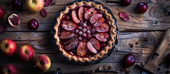 Fototapete - Homemade pie featuring plums and apples set against a dark wooden background Rustic style Selective focus. with copy space image. Place for adding text or design