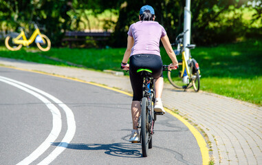 Wall Mural - Cyclist ride on the bike path in the city Park
