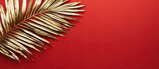 Aufkleber - Shiny gold glossy palm tree leaf isolated on a red background Flat lay top view with copyspace Minimalist fashion idea