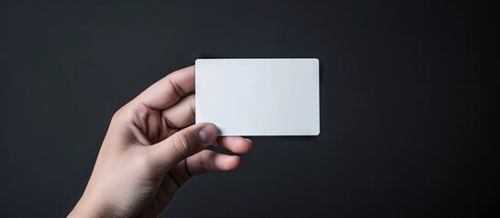 Leinwandbilder - Hold a blank mockup business card for branding and logo printing. with copy space image. Place for adding text or design