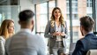 © N7 - 'Office Presentation with Female Speaker' – A woman presenting in front of a blurred office background.