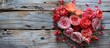 © vxnaghiyev - A beautiful bouquet of roses on a wooden background suitable for a Valentine card Colorful flowers paired with a Valentine s Day heart toy Set against a wooden backdrop with copy space A bunch of var