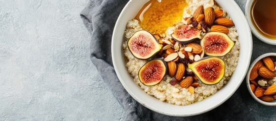 Poster - Gluten free amaranth and quinoa porridge breakfast bowl topped with figs caramelized almonds raisins and honey on a rustic white table Top view overhead flat lay Copy space