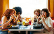 © oneinchpunch - Multiethnic group of friends having meal at 80s vintage diner restaurant - Multiracial young people bonding and having fun, eating in an american fast food burger house