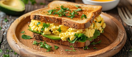 Leinwandbilder - Avocado Sandwiches with scrambled eggs sliced avocado and egg on toasted bread for a nutritious breakfast or snack copy space
