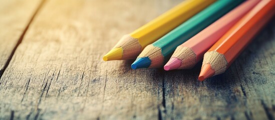Poster - Close up of colored pencils on a wooden table. with copy space image. Place for adding text or design